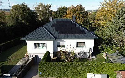 Drohnenaufnahme eines Einfamilienhauses nach der Sanierung von vorne